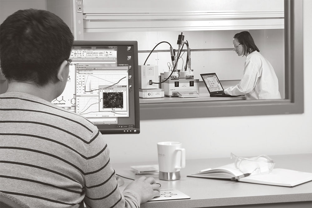 scientists working with AutoChem and reviewing data on computers