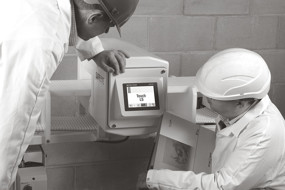 two technicians setting up METTLER TOLEDO food metal detector