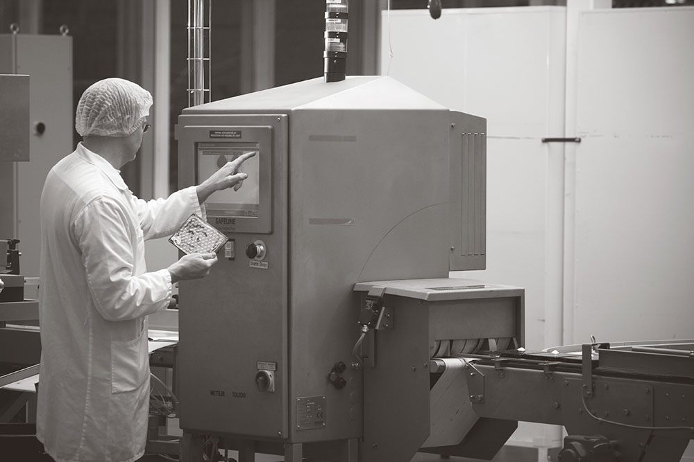 technician using a METTLER TOLEDO manufacturing machine
