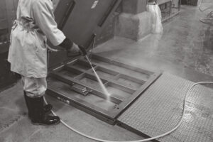 Floor scale undergoing routine maintenance washdown in a food processing plant.