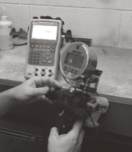 Tech Calibrating a pressure gague