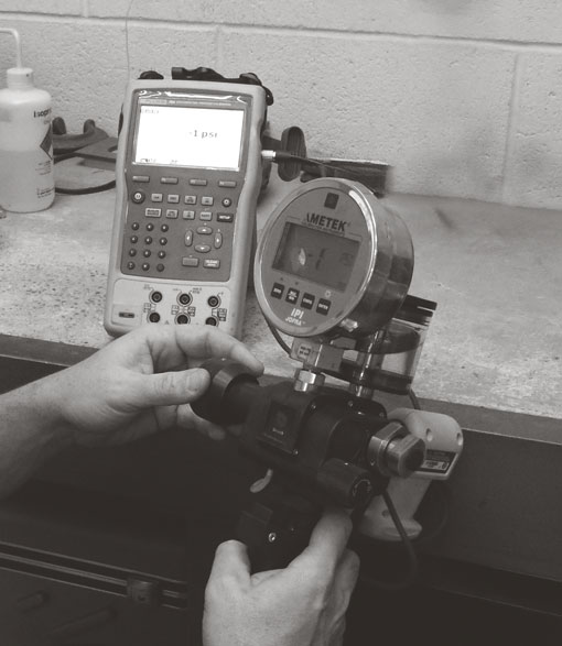 Tech Calibrating a pressure gague