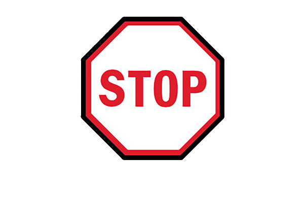 White stop sign with red lettering