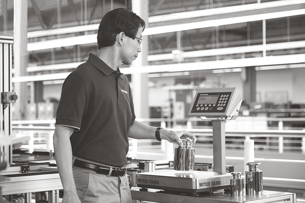 technician servicing a METTLER TOLEDO bench scale