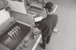 technician calibrating a scale with weights