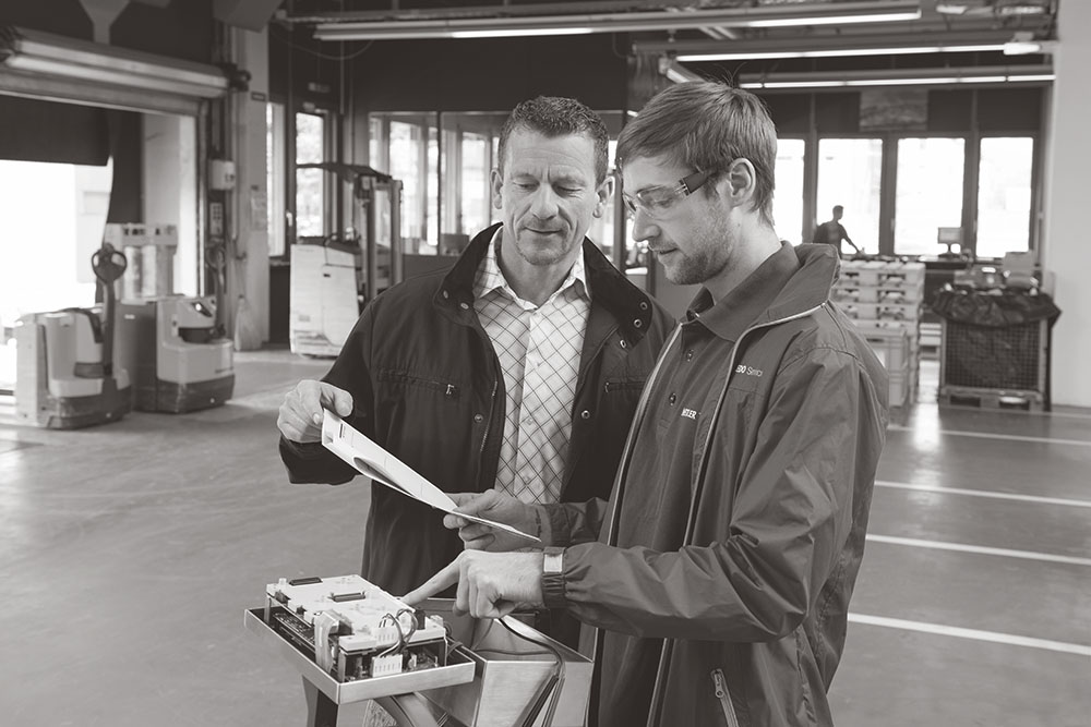 two technicians reviewing instructions for scale, discussing scale services