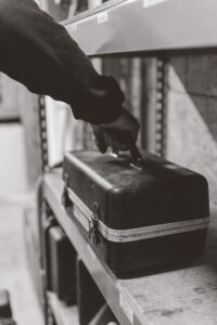 Hand picking up a toolbox
