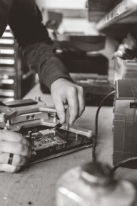 Hands of engineer doing maintenance on an industrial scale