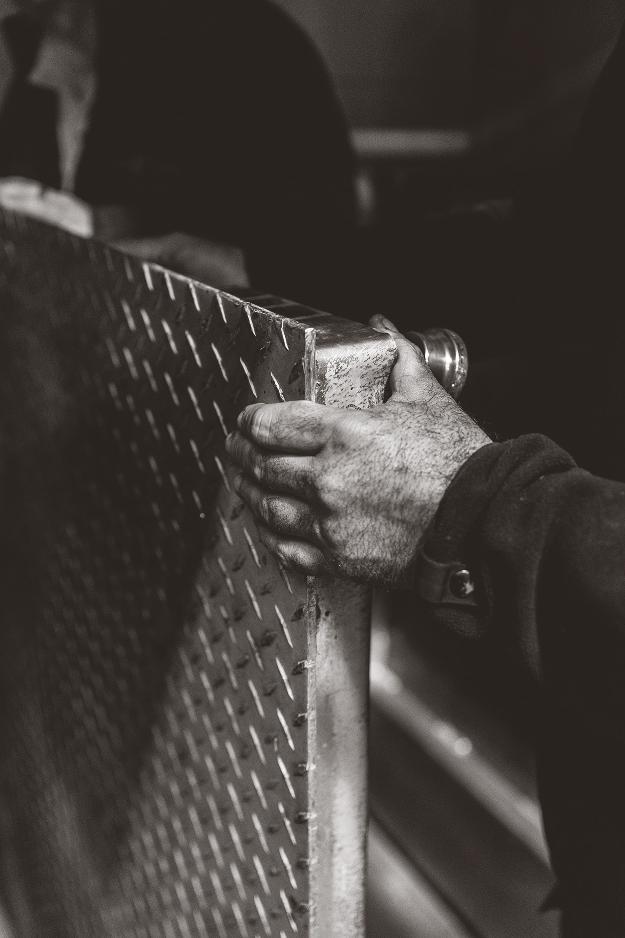Close-up of engineers moving a large industrial scale