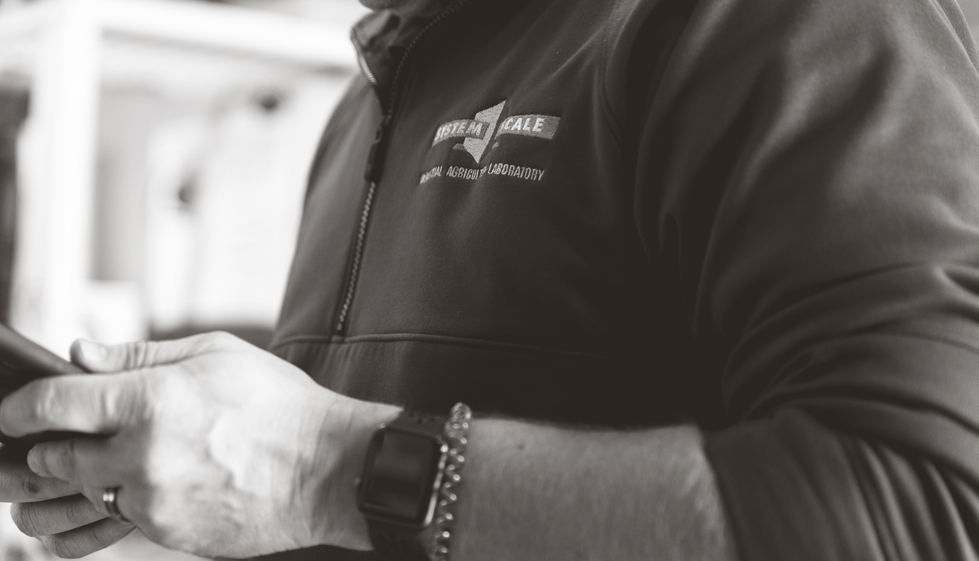 Close-up of an engineer wearing a jacket with the System Scale logo