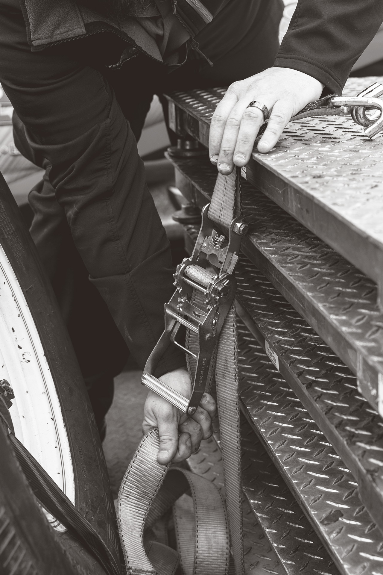 Close-up of an engineer's hands as he ratchets the platforms of industrial scales together