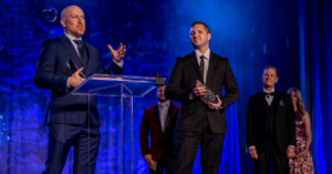 System Scale's CEO, Mike Sale, accepting a Mira Award for Digital Transformation on behalf of System Scale along with Growth Heroes CEO Jim Bartek.