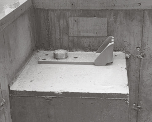 Truck scale baseplate sitting on foundation pier. 