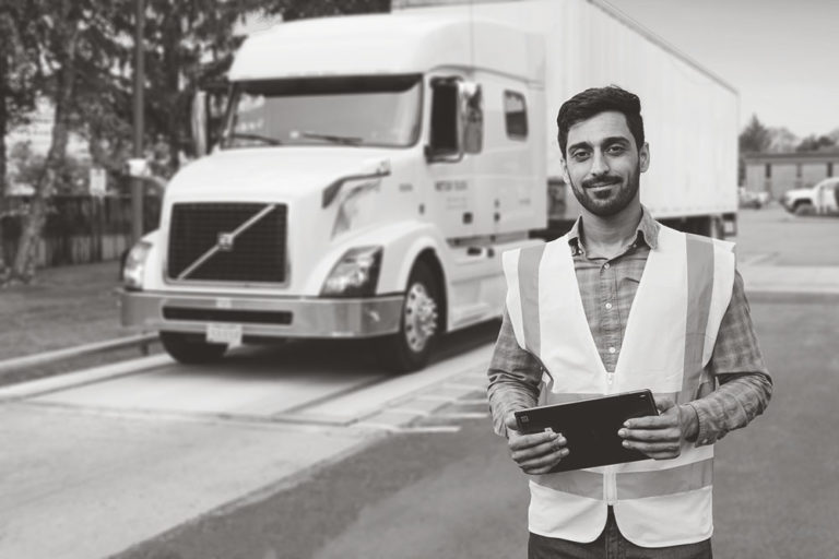 Truck Pass Operator with Tablet ready to schedule your calvault review and truck scale services