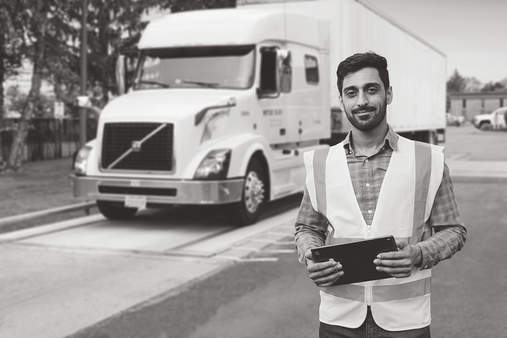 Truck Pass Operator with Tablet ready to schedule your calvault review and truck scale services