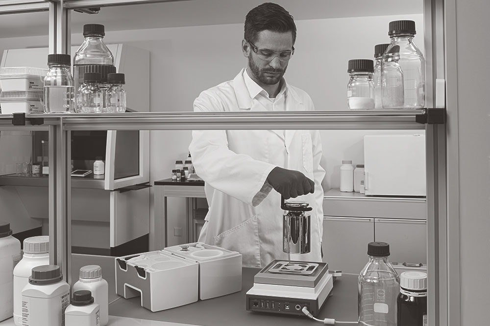 A pharmaceutical rep checks the weight of various liquids