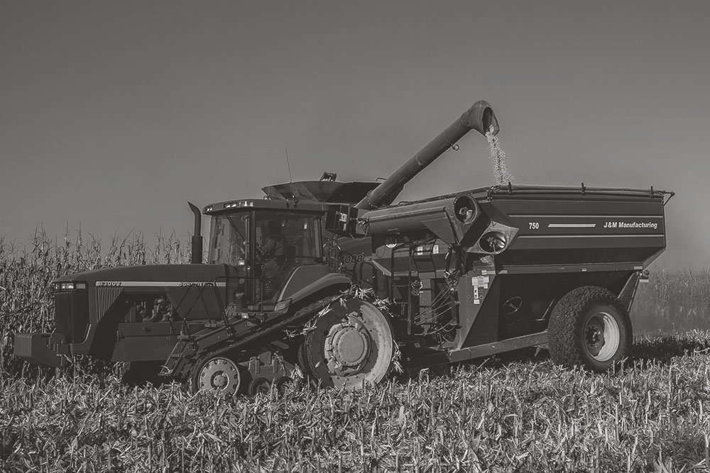 combine emptying out into hopper with tractor